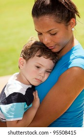 Beautiful Young Multicultural Woman And Boy In A Outdoor Park Setting.