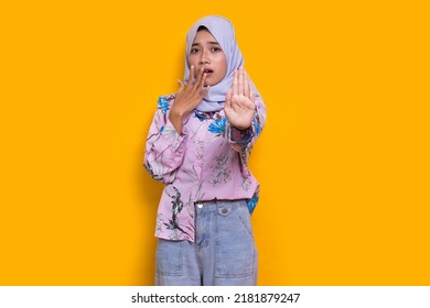 Beautiful Young Muslim Woman Hand Doing Stop Sign With Serious Expression Defense Gesture Isolated On Yellow Background
