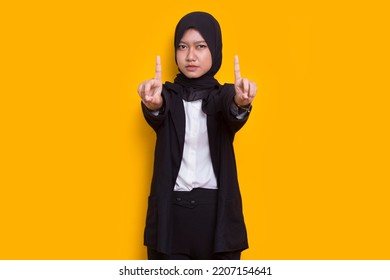 Beautiful Young Muslim Woman Hand Doing Stop Sign With Serious Expression Defense Gesture Isolated On Yellow Background
