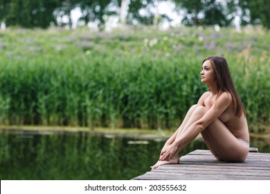 Nude by the lake