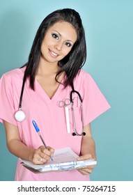 Beautiful Young Nurse Assistant Holding Clipboard