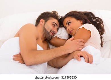 A Beautiful Young Passionate Couple In Bed