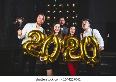 Beautiful Young People At A Corporate Party Holding Balloons 2020. Happy New Year Celebration. Club Party With Friends