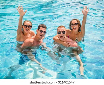 Beautiful young people having fun in swimming pool, smiling. - Powered by Shutterstock