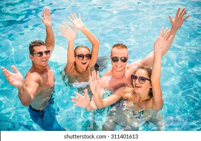 Beautiful Young People Having Fun In Swimming Pool, Smiling.