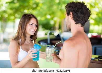 Beautiful young people talking in a beach bar