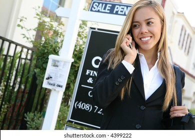 A Beautiful Young Real Estate Agent Woman On The Phone