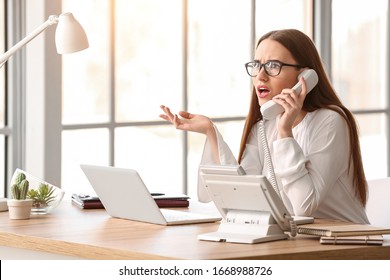 Beautiful young secretary working in office - Shutterstock ID 1668988726