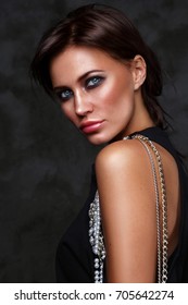 Beautiful young slim tanned woman with smoky eye make-up