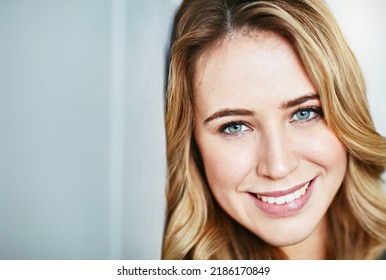 Beautiful, Young And Smiling Female Face Looking Happy And Confident With Copyspace. Closeup Of A Blonde Natural Beauty With Perfect Teeth And Skin. Portrait Of A Happy, Content Woman Alone