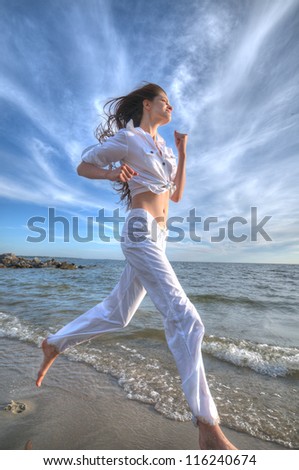 Similar – Young woman walks on the beach