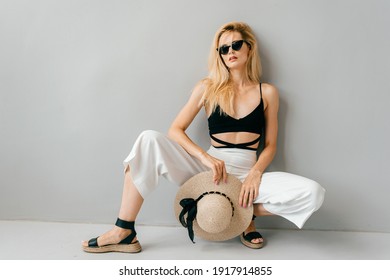 Beautiful young stylish blonde model posing in studio