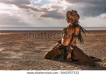 beautiful young stylish tribal woman in turban outdoors at sunset