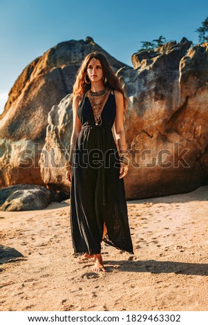 beautiful young stylish woman on the beach at sunset