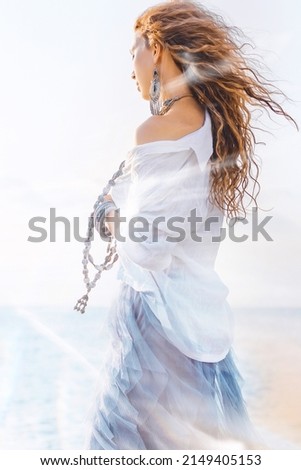 beautiful young stylish woman on the beach