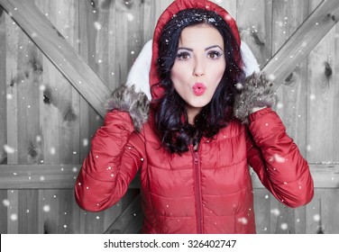 Beautiful  young surprised woman wearing winter hooded jacket and gloves covered with snow flakes. Christmas portrait concept.  - Powered by Shutterstock