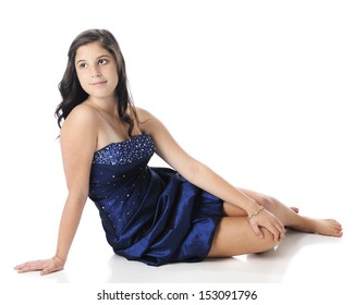 A Beautiful Young Teen Sitting Barefoot In Her Strapless Blue Prom Dress.  On A White Background.