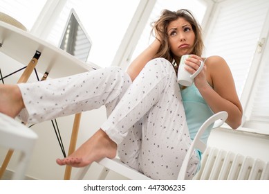 Beautiful Young Tired Woman Drinking Coffee In The Morning And Can't Wake Up.