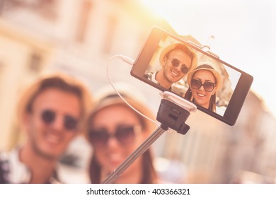 Beautiful Young Tourist Couple Taking Picture Of Themselves With Selfie Stick - Sunset, Golden Hour, Traveling