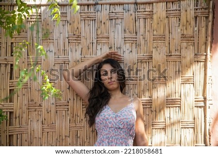 Similar – Woman with sunglasses looking at camera over garden fence