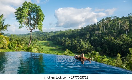 Beautiful Young Traveler Is Relaxing In The Pool Lying On The Edge Of The Swimming Pool In A Luxury Villa Nearby Galle, Sri Lanka