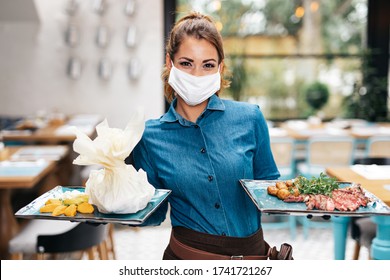 Beautiful Young Waitress With Face Protective Mask Working In Exclusive Restaurant. Coronavirus Or Covid-19 Concept.