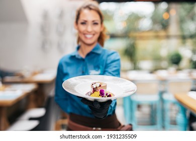 Beautiful young waitress working in exclusive restaurant.
