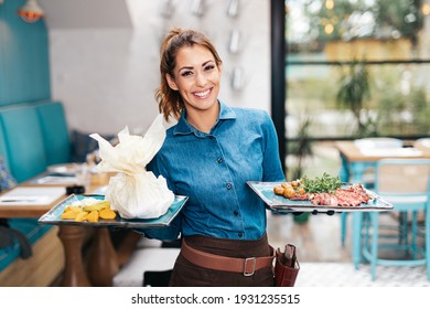 Beautiful young waitress working in exclusive restaurant. - Shutterstock ID 1931235515
