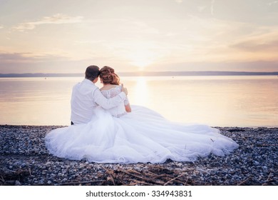 Beautiful young wedding couple at the shore