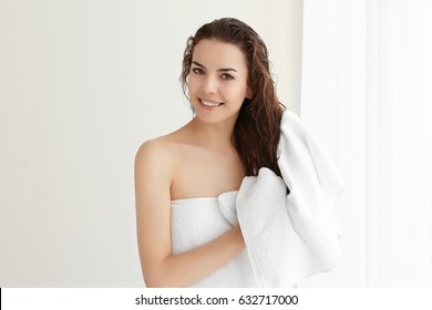 Beautiful young woman after shower at home