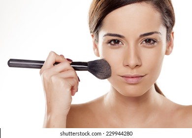 Beautiful Young Woman Apply Powder On Her Face