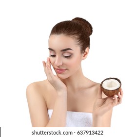 Beautiful Young Woman Applying Coconut Oil Onto Skin On White Background