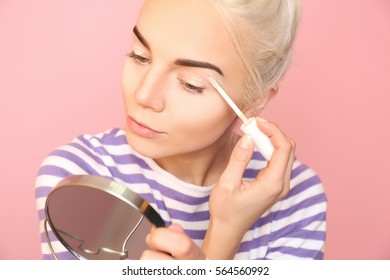 Beautiful Young Woman Applying Concealer On Eyelid