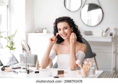 Beautiful Young Woman Applying Foundation At Home