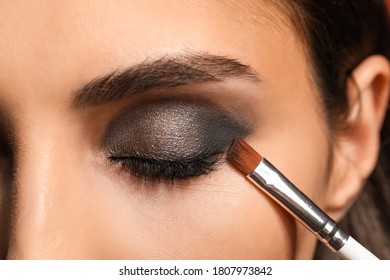 Beautiful young woman applying makeup, closeup - Shutterstock ID 1807973842