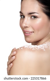 Beautiful young woman applying scrub treatment on the skin on white