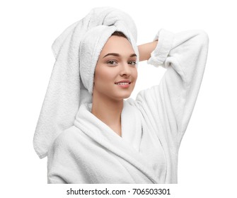 Beautiful young woman in bathrobe after shower on white background