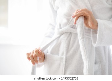Beautiful young woman in bathrobe at home, closeup