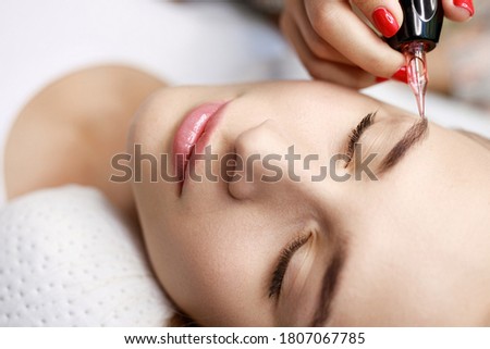 Beautiful young woman  in beauty salon. Woman getting facial treatment. Perfect trendy eyebrows and eyelashes. Female with healthy glow smooth skin.
