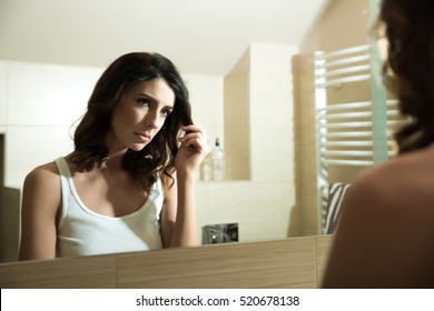 A Beautiful Young Woman Being Sad At The Mirror In The Bathroom