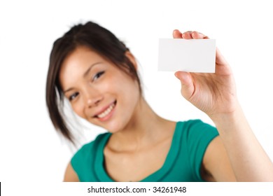Beautiful young woman with big smile displaying blank business card. Shallow depth of field, focus on card. Isolated on white background.