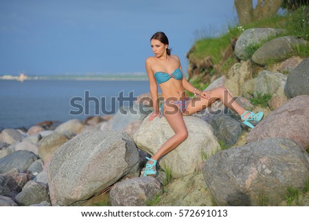 Beautiful young woman in bikini at the beach