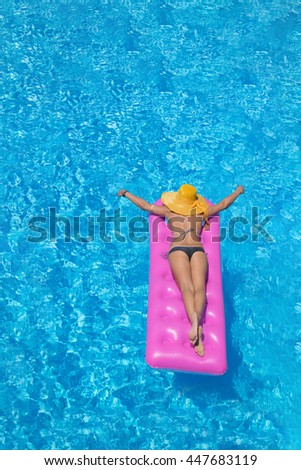 Beautiful young woman in bikini Relaxing in a swimming pool