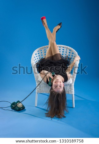 Similar – Image, Stock Photo Young woman lying upside down on an armchair