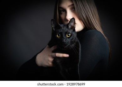 Beautiful Young Woman In Black Sweater With Black Cat, 