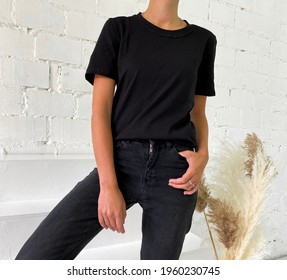Beautiful Young Woman In Blank Black T-shirt And Jeans
