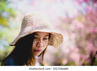 beautiful young woman with blooming cherry blossoms sakura flowers