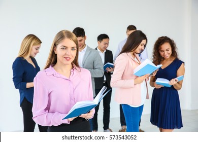 Beautiful Young Woman With Book In Club