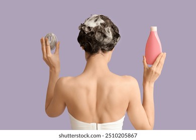 Beautiful young woman with bottle of shampoo and hair brush on purple background, back view - Powered by Shutterstock