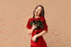 Beautiful Young Woman With Bouquet Of Red Roses And Confetti On Brown Background. Valentine's Day Celebration